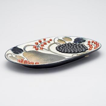 BIRGER KAIPIAINEN, A CERAMIC DISH. A pear and berries. Signed Kaipiainen Arabia. 1970s.