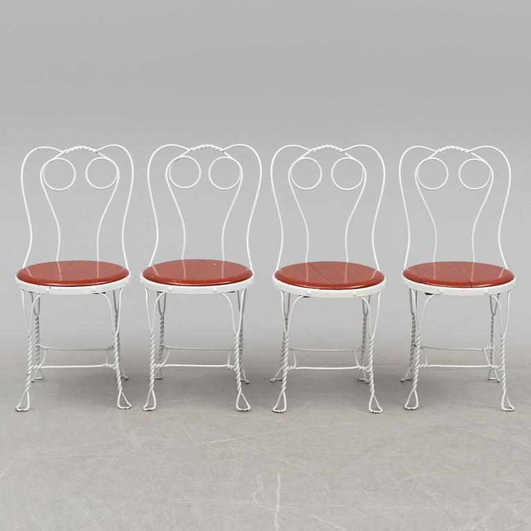 A garden table and four chairs, first half 20th century.