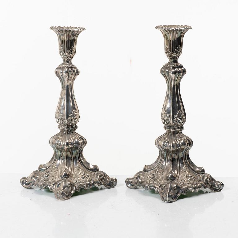 A pair of rococo-style silver candle sticks, early 20th century.