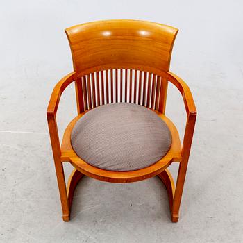 A cherry wood model 606 'Barrel' chair by Frank Lloyd Wright from Cassina.