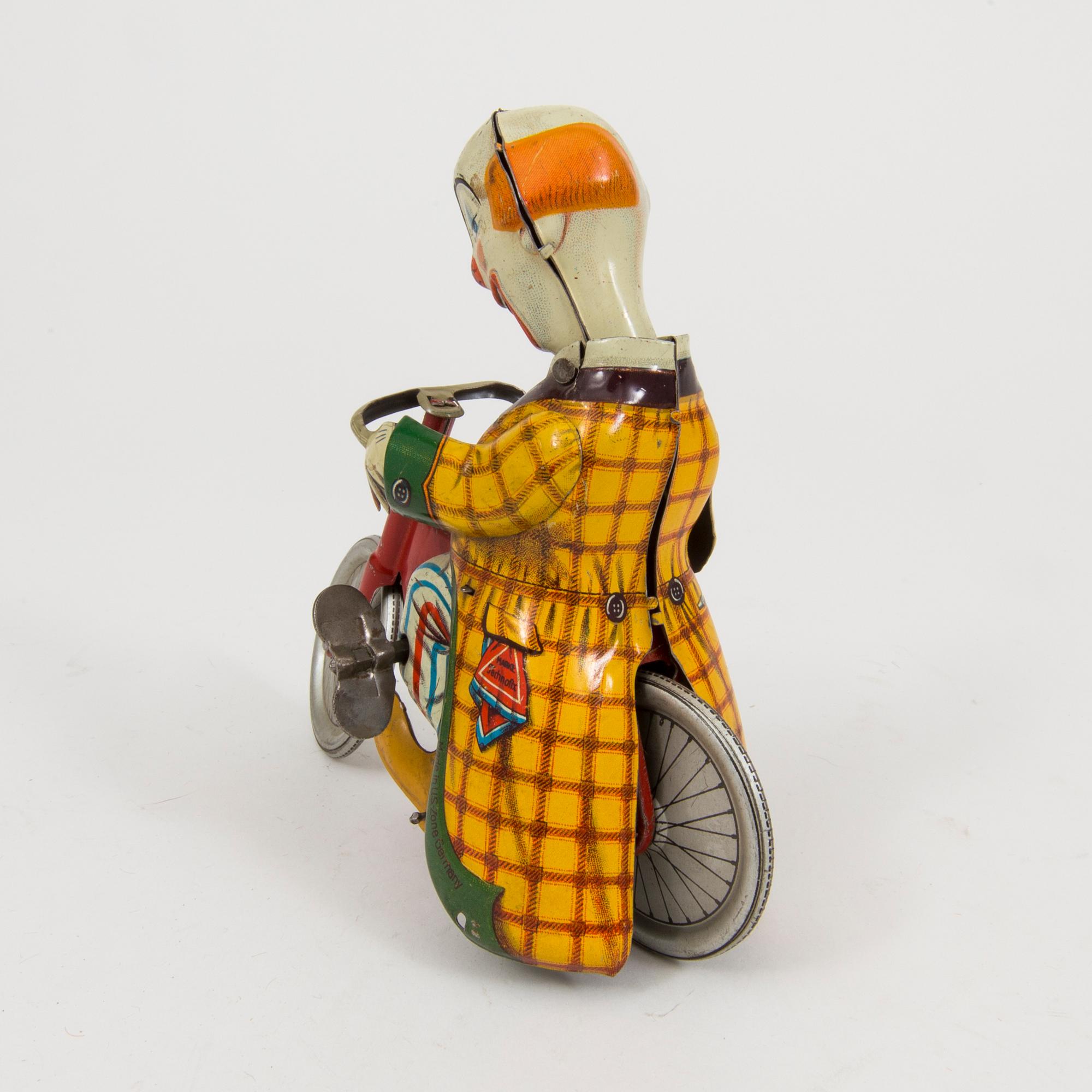 A tinplate Technofix bicycling clown Germany c. 1950.