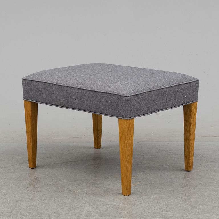 An easy chair and foot stool by Frits Hansen for Carl Hansen & Son.