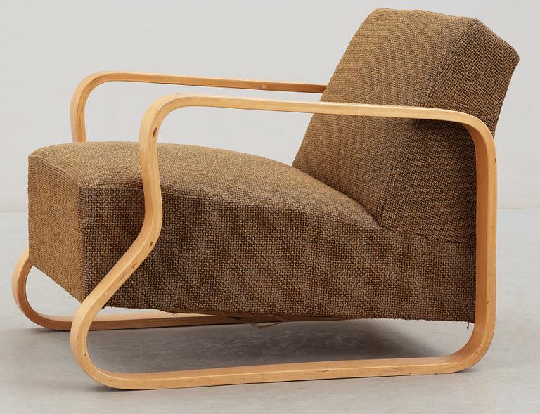 An Alvar Aalto laminated birch 'padded Paimio chair', upholstered in yellow and black fabric.