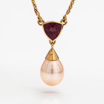 A 14K gold necklace with a tourmaline and cultured pearl.