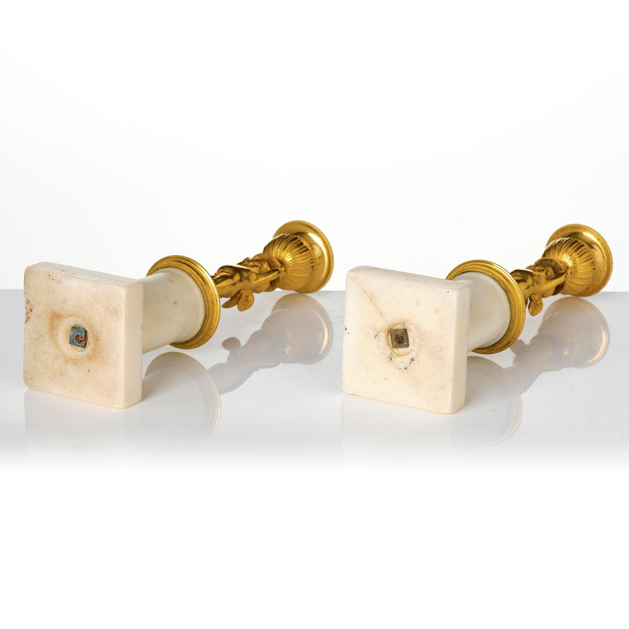 A pair of late Gustavian white marble and ormula candlesticks.