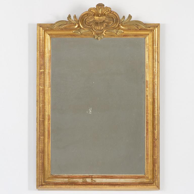 A Gustavian giltwood frame with mirror glass, Stockholm, late 18th century.