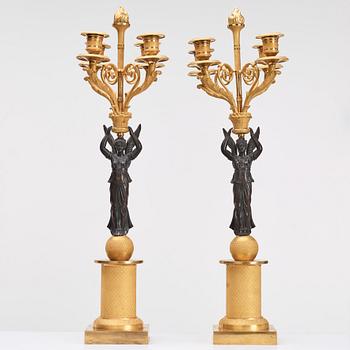 A pair of Empire four light candelabra.