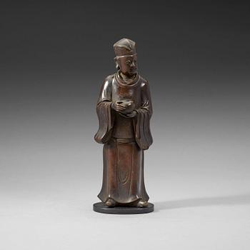 A bronze figure of a Mandarin official with a box, Qing dynasty, 19th Century.