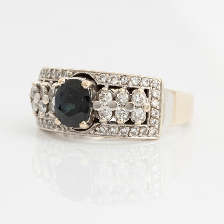 Ring with dark sapphire and brilliant-cut diamonds.