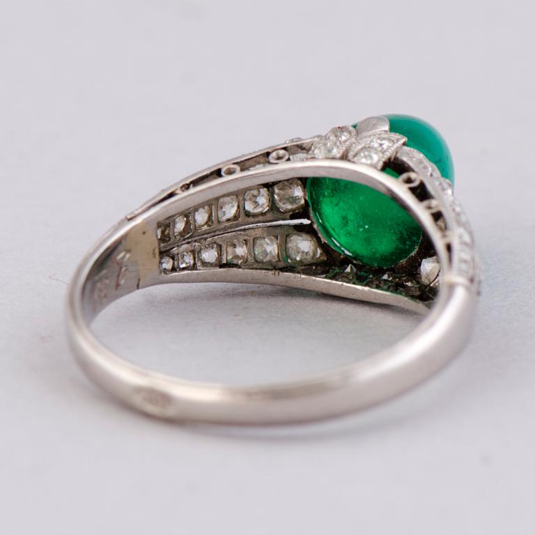 A RING, cabochon cut emerald, old cut diamonds. Alexander Tillander, St Petersburg 1855-1918.