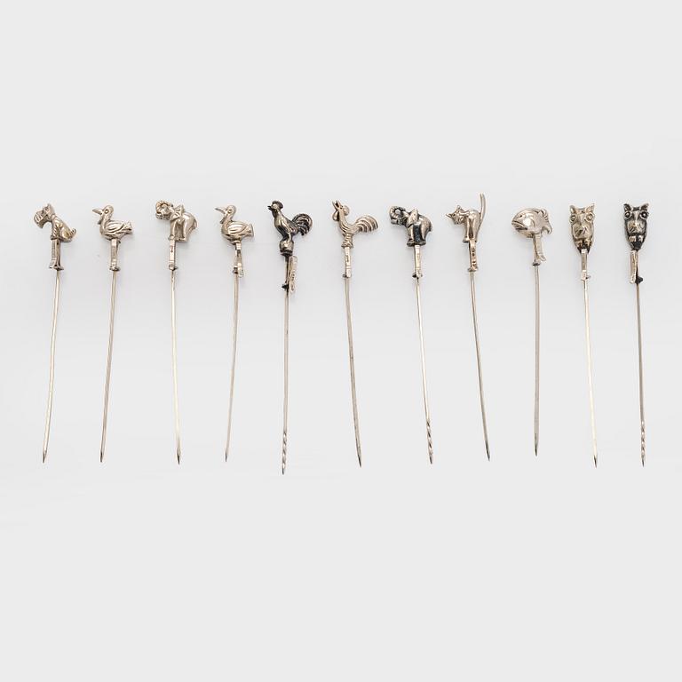 A set of twelve silver coasters and cocktail sticks 11 pcs,  Suomen Kultaseppä Oy 1935 and Kultakeskus 1983.