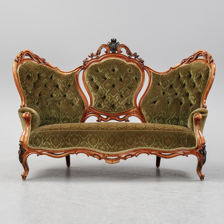 A rococo style sofa, four chairs and a table, second half of the 19th Century.