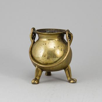 A 17th century brass bowl.