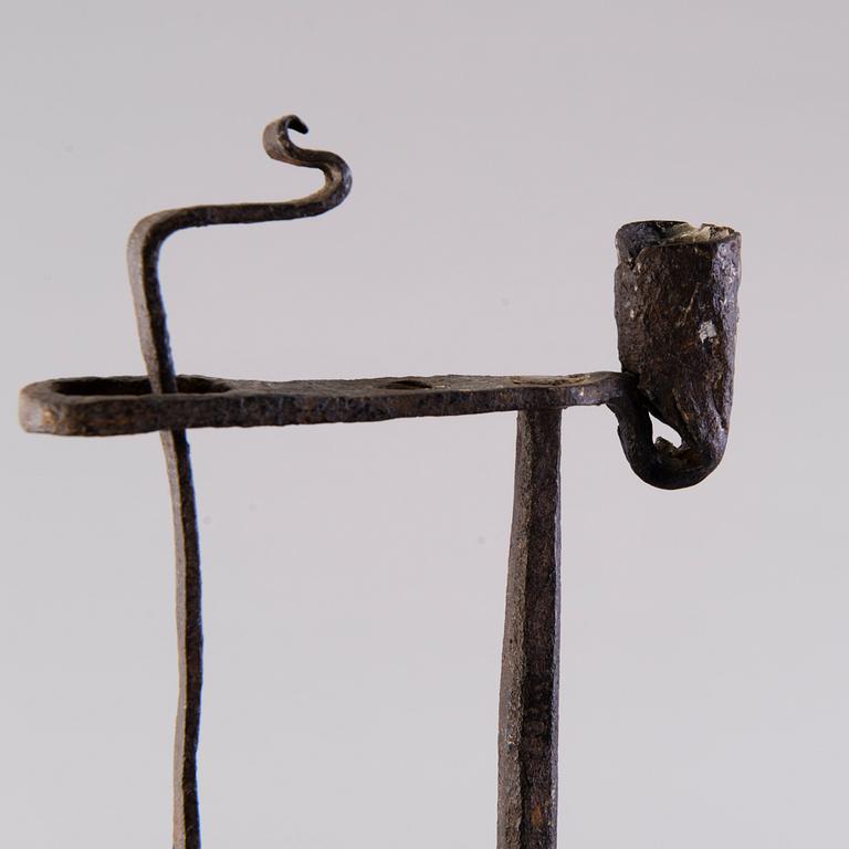 A 18th century wrought iron rush light and candle holder.