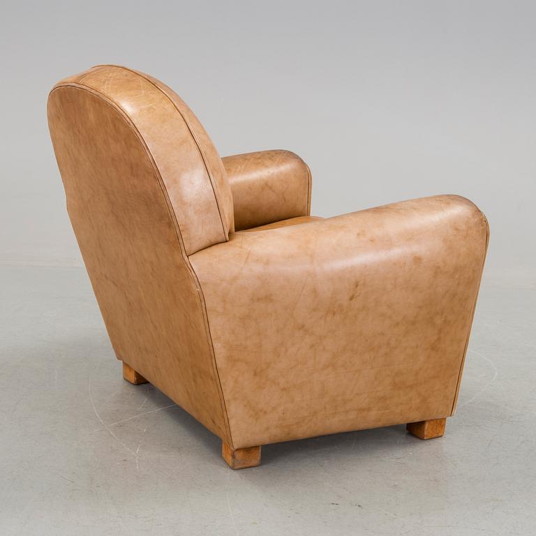 A brown leather armchair by grange, the second half of the 20th century.
