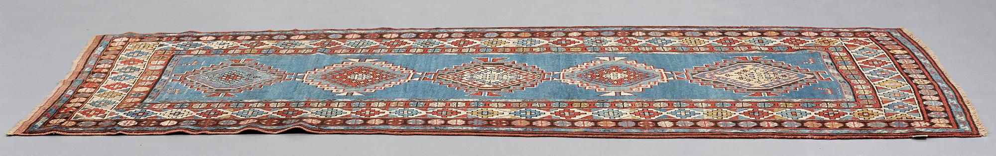 A RUNNER, a semi-antique Caucasian, ca 303,5 x 129,5-140,5 cm (as well as one end with 2,5 cm flat weave).