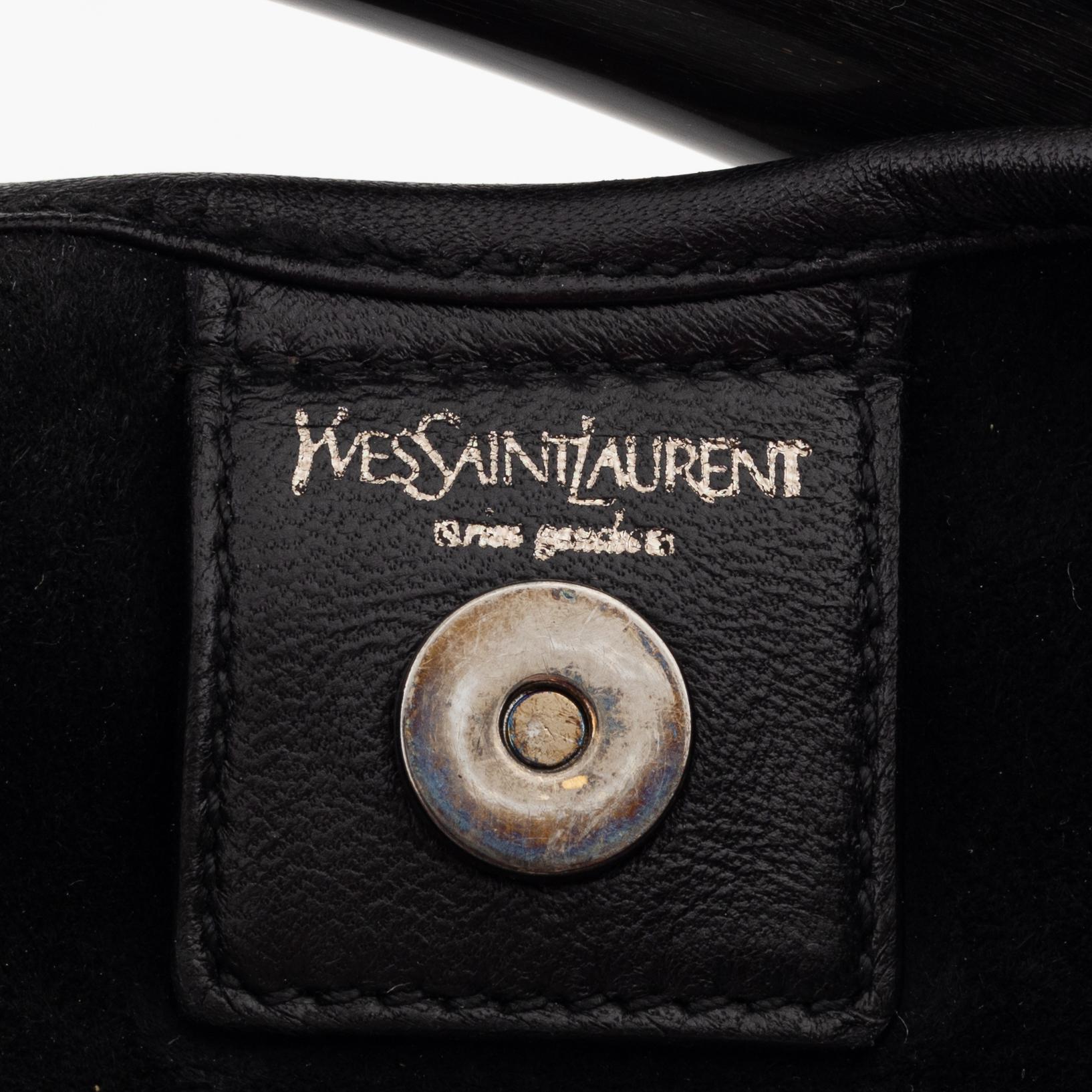 Yves Saint Laurent, a black leather and horn hobo bag.