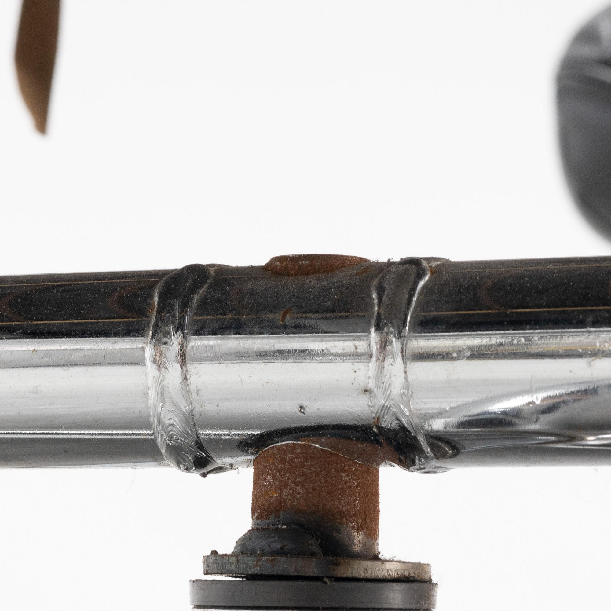 A leather and chrome lounge chair and foot stool, 1970's/80's.