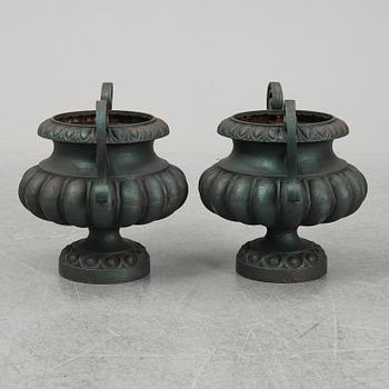 A 20th Century pair of cast iron flower pots.