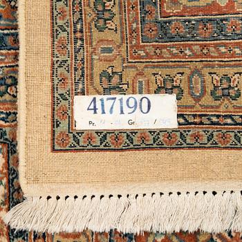 An oriental carpet. Circa 345x245 cm.