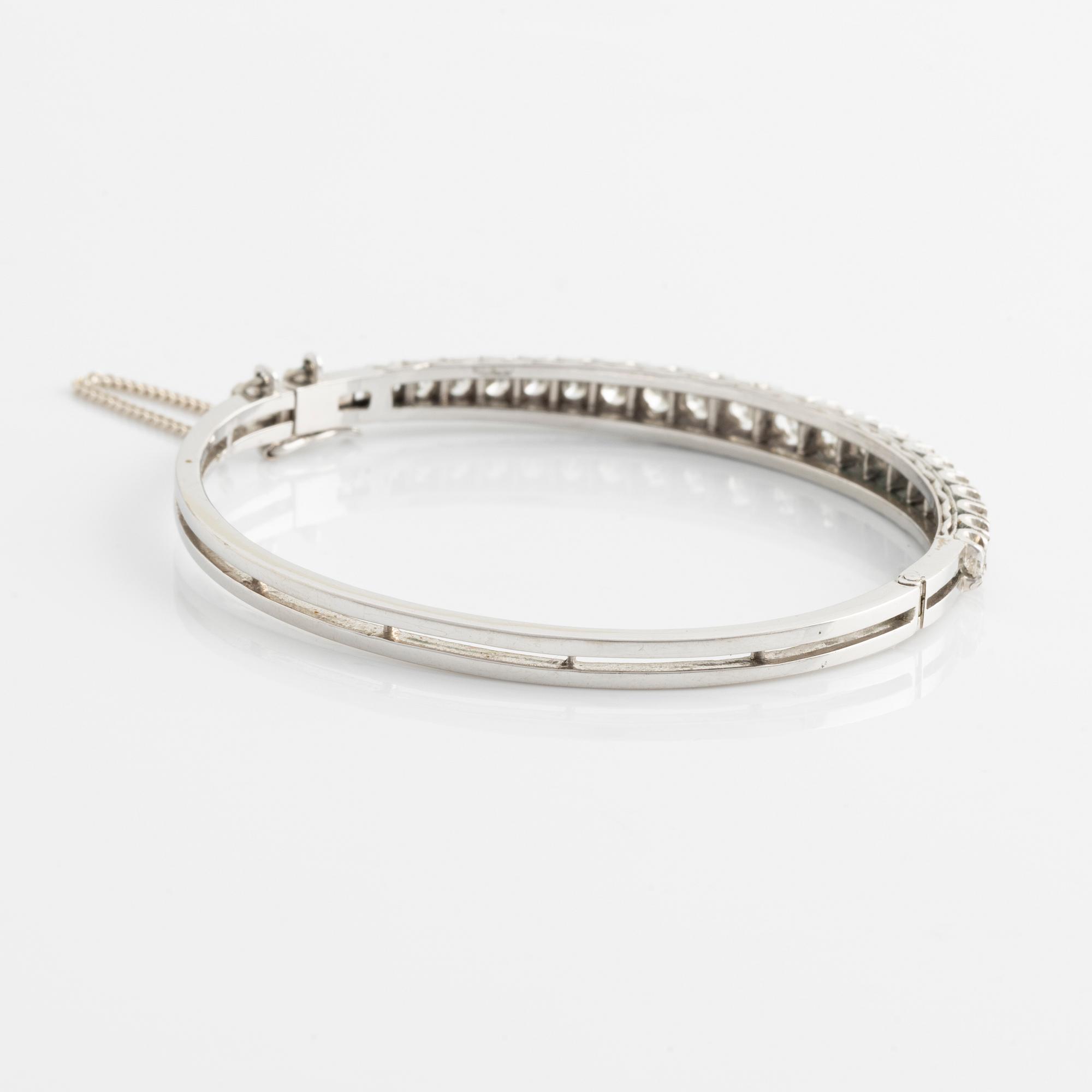 14K gold bangle with round brilliant-cut diamonds.