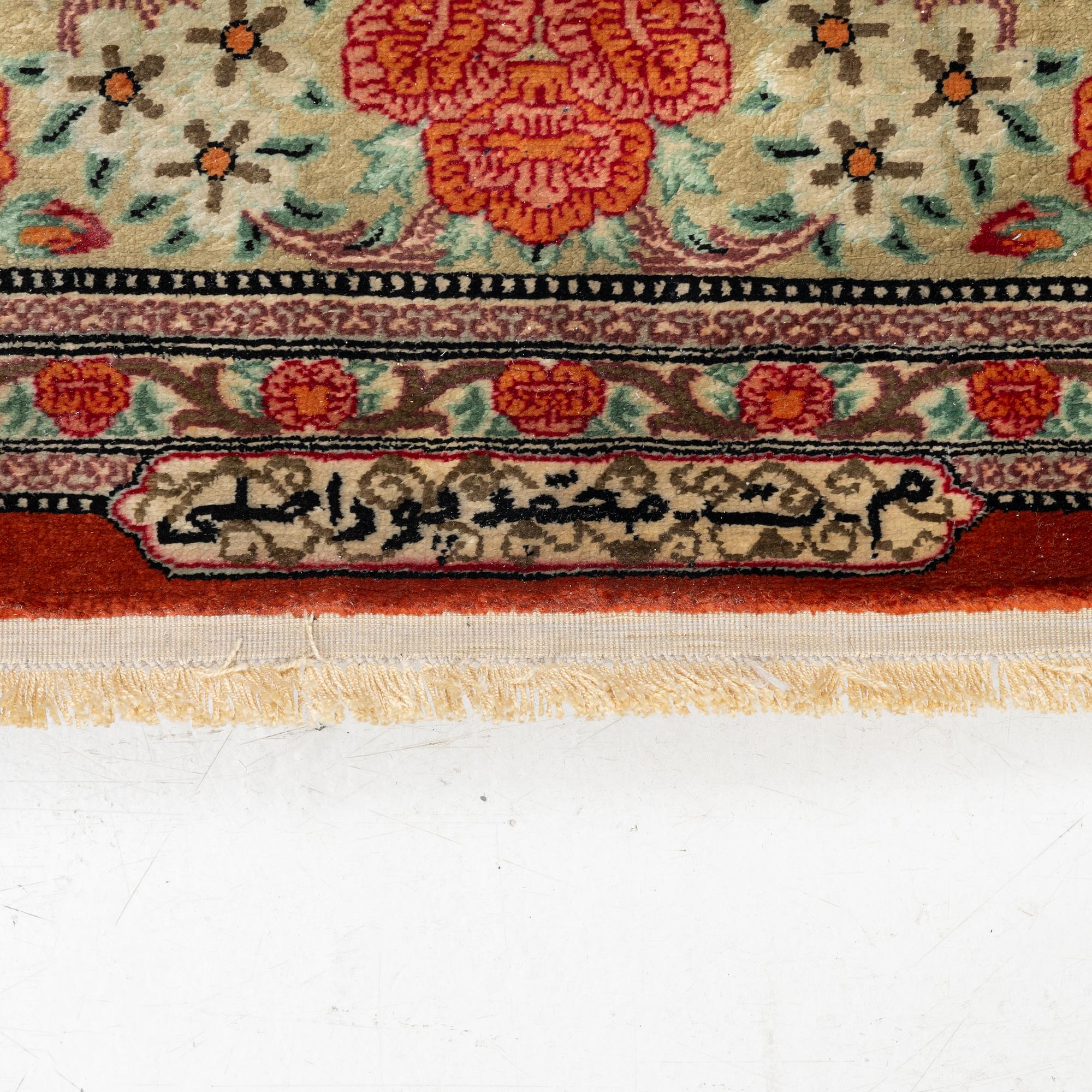 A signed silk Qum rug. c. 154 x 103 cm.