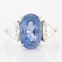 Ring with sapphire and triangle-cut diamonds.