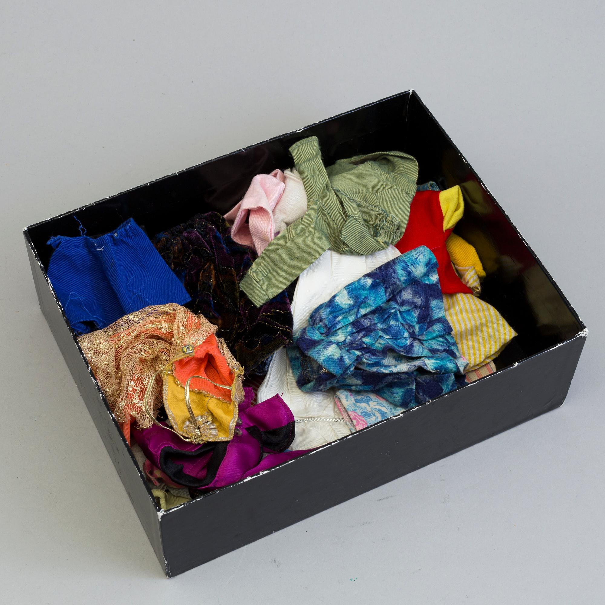 A plastic doll's house with six dolls, furniture and clothes, 20th century.