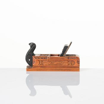 A Swedish carved ebony, boxwood and bone plane, dated 1748.