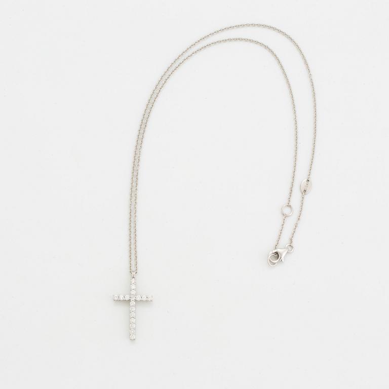 Brilliant-cut diamond cross pendant.