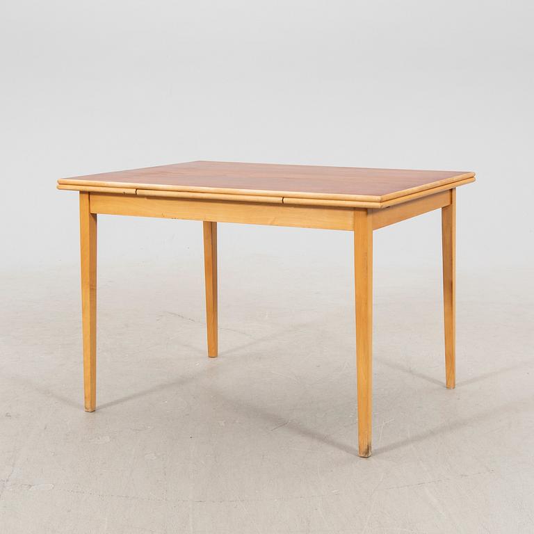 A 1960s teak and beech dining table.