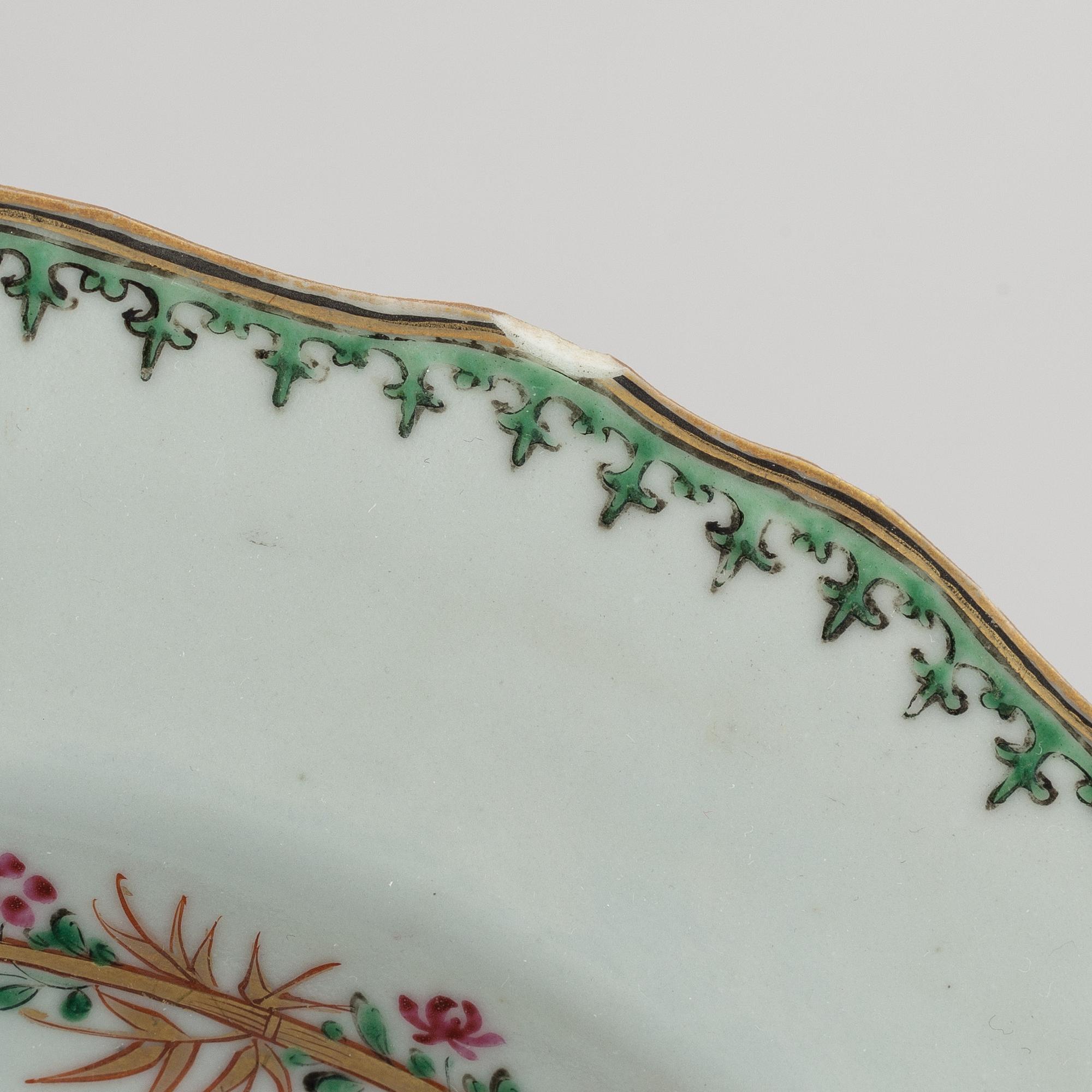 A pair of armorial dinner plates and a group of three odd famille rose plates, Qing dynasty, Qianlong (1736-95).