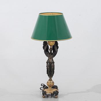 An early 20th century empire style gilded bronze table lamp.