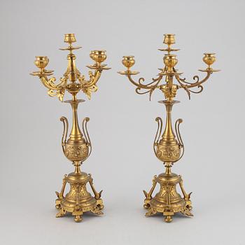 A pair of late 19th century brass candelabra for five candles.