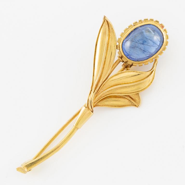 Brosch, 18K guld i form av blomma med cabochonslipad safir.