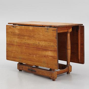 A drop-leaf table, 18th Century.