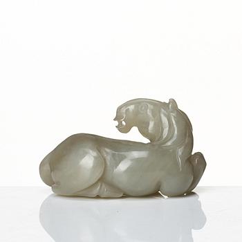 A carved nephrite figure of a reclining horse, Qing dynasty.