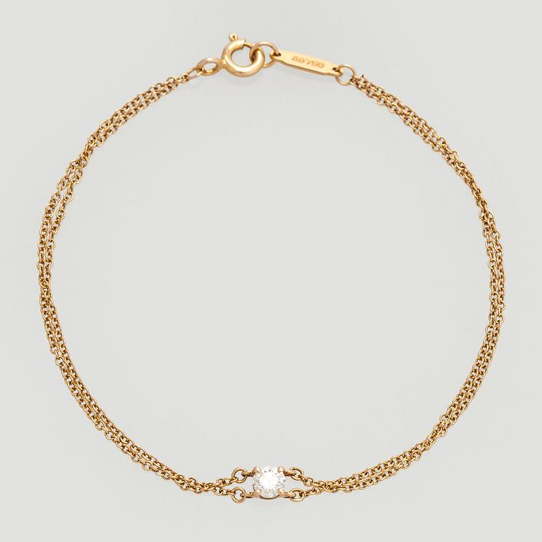 Tiffany & Co, armband, 18K guld med en briljantslipad diamant.