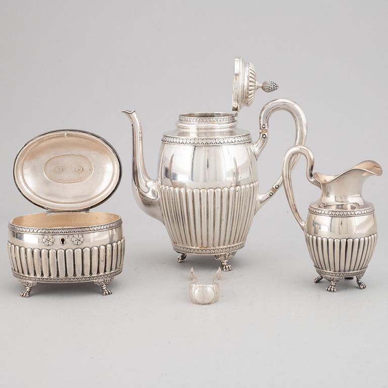 A swedish silver coffee pot, creamer sugar box and sugar tongs, mark of Samuel Pettersson, Linköping 1900.