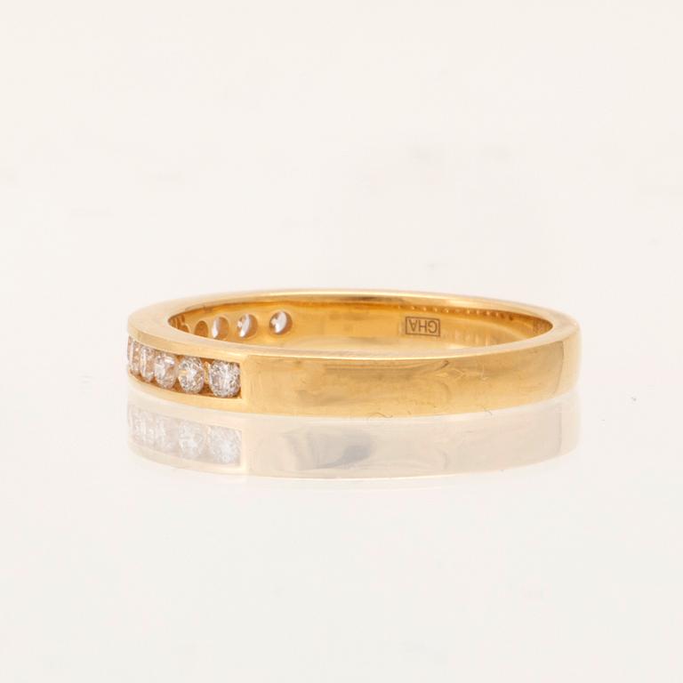 An 18K gold half-eternity ring set with round brilliant-cut diamonds.