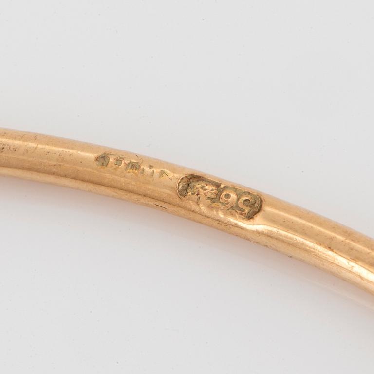 A 14K gold bangle set with old- and rose-cut diamonds.