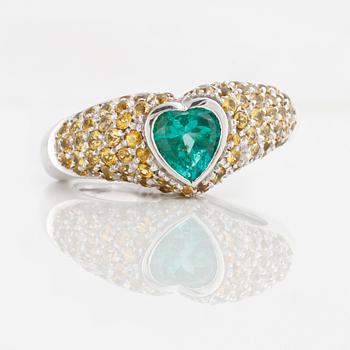 A circa 1.50 cts yellow sapphire and circa 0.90 cts heart-cut emerald ring.