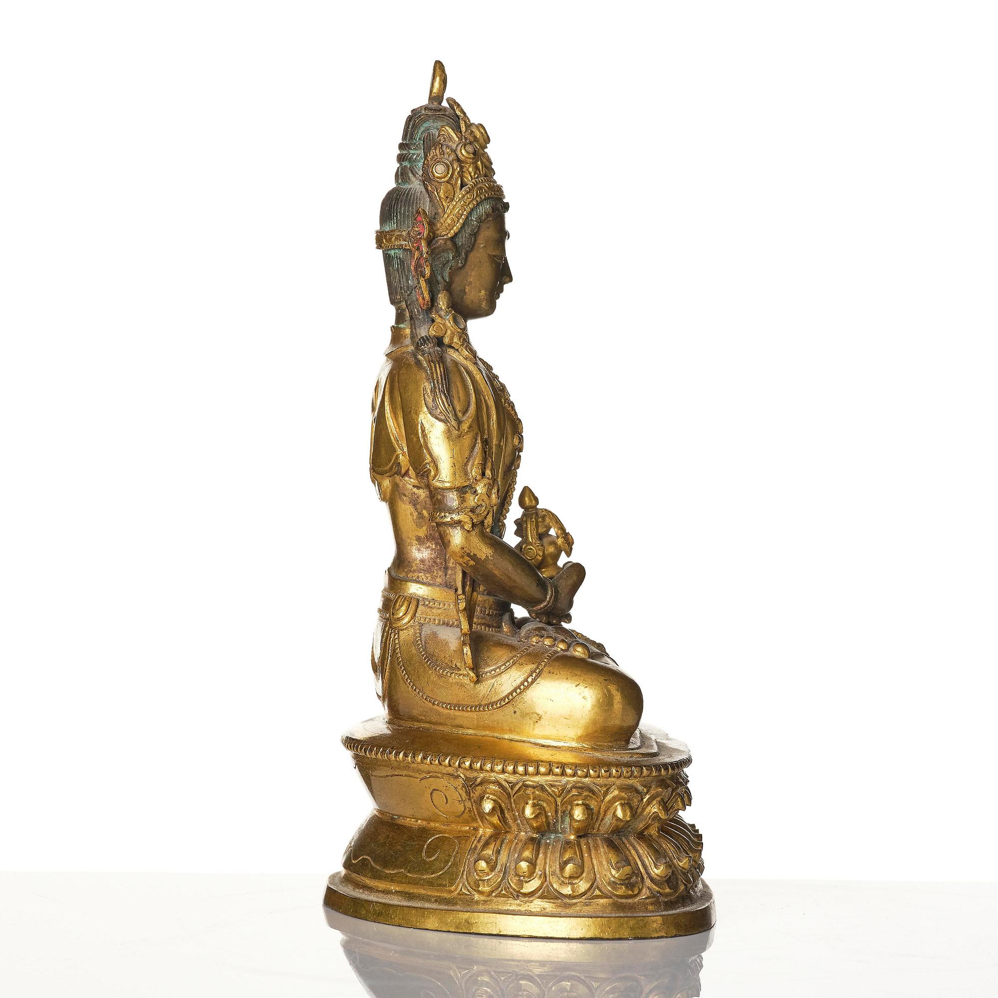 A gilt copper alloy figure of Amitayus, Tibet, 17th/18th century.