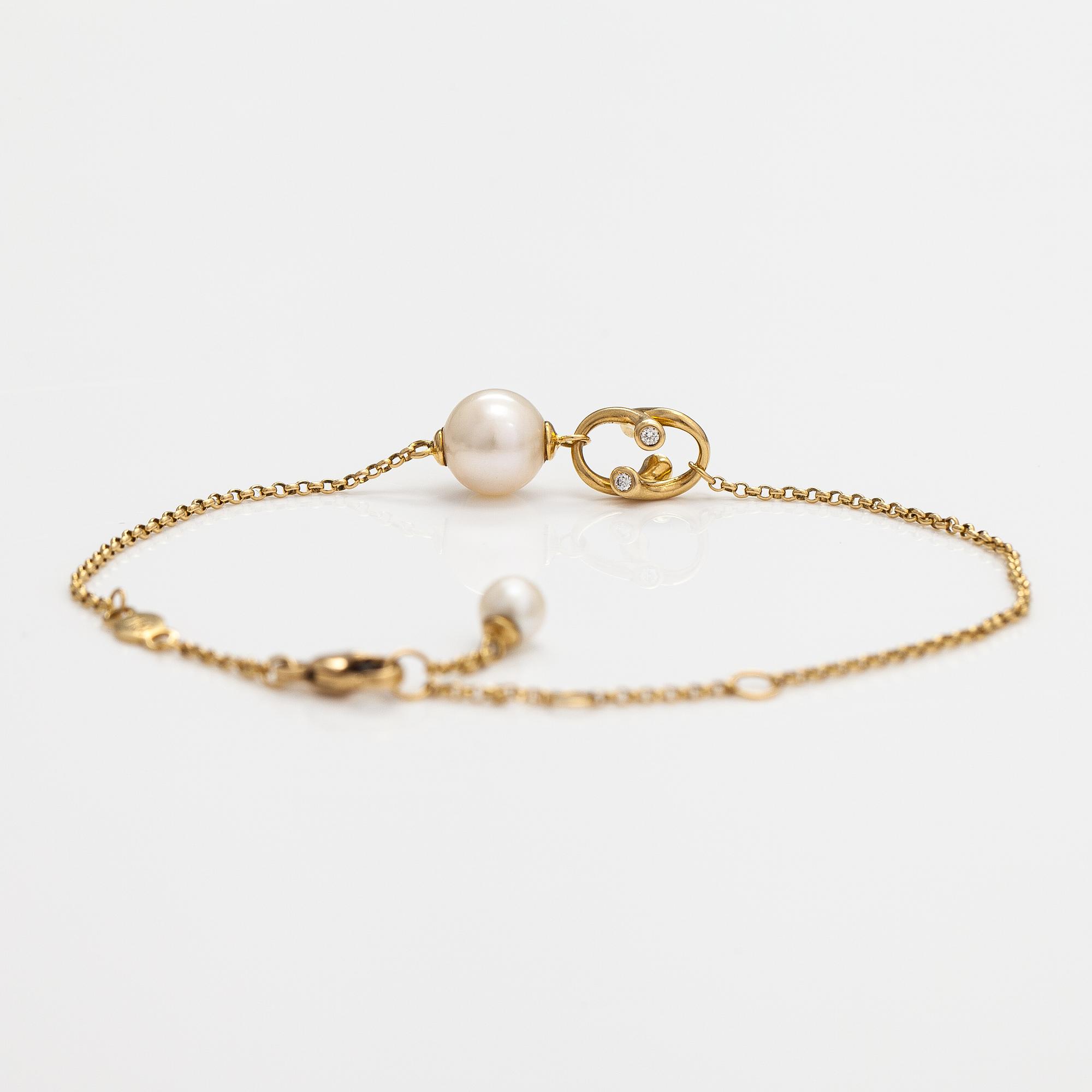 Georg Jensen, An 18K gold bracelet "Magic" with a cultured pearl and diamonds ca. 0.048 ct in total, Denmark.