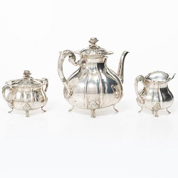 A Rococo style silver coffee pot, cream jug and sugar bowl, 20th century, Swedish import mark.