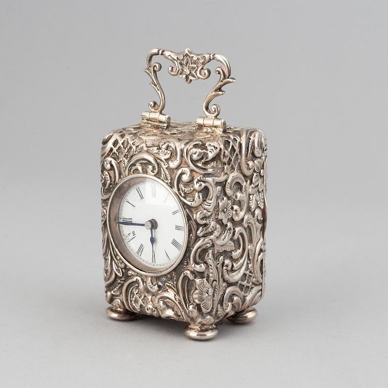 A rococo-style silver clock, mark of Henry Matthews, Chester 1903.