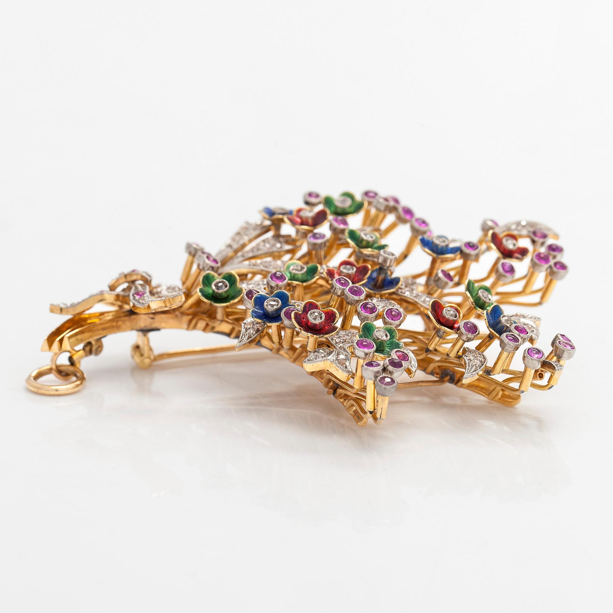 A 17K gold brooch/pendant with rose-cut diamonds, cabochon-cut rubies and enamel.