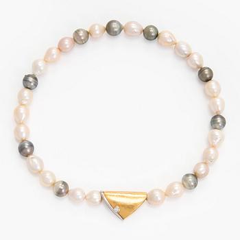 Ole Lynggaard, A cultured pearl necklace, clasp in 18K gold with a round brilliant-cut diamond.
