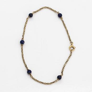 A 14K gold bracelet with lapis lazuli.