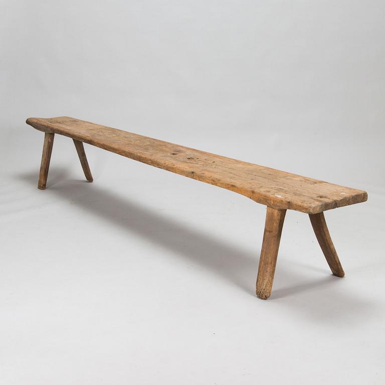 An 18th-century wooden bench dated 1782 with initials.